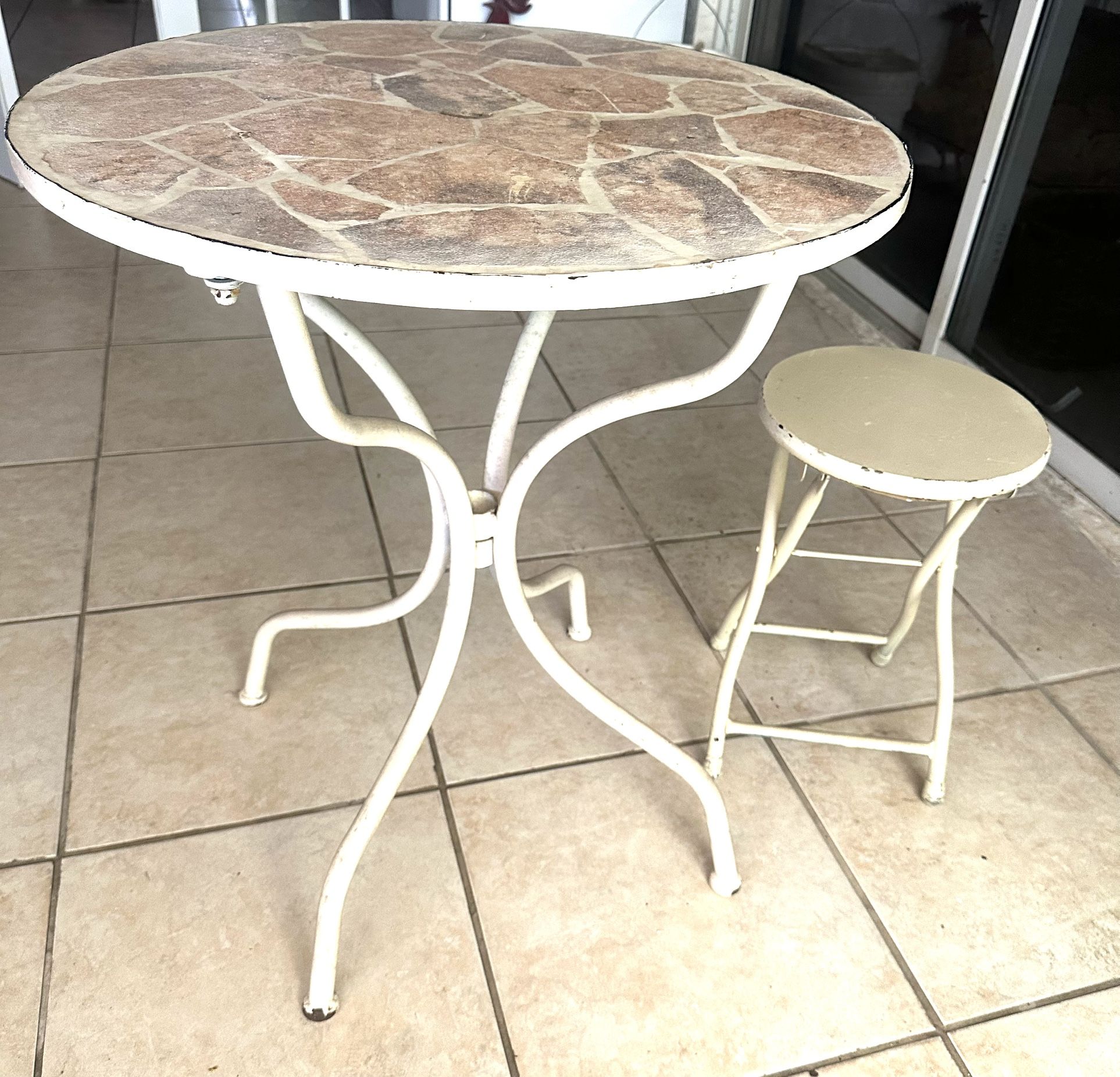 Patio table with a matching stool.