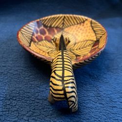 Hand-carved African wooden bowl featuring a zebra drinking from it.