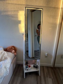 Mirror with jewelry storage