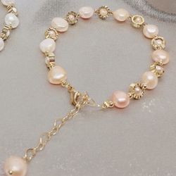 38ct Baroque Freshwater Pink/Orange colored 10x, 6.5mm Pearls and beads make this simple but elegant bracelet at 6.5-8 inches great luster