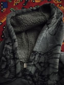 Grey pull over robe that has Chucky and Tiffany on it the dolls from child play