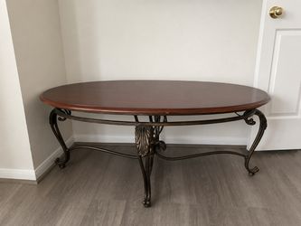 Oval Wood Coffee Table with Ornate Metal Base