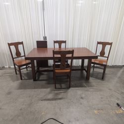 Traditional Brown Wood Dining Table with four chairs and leaf