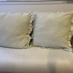 Light green large cotton throw pillow with a waffle texture and ruffled edges