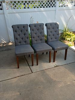 Three grey dining room chairs