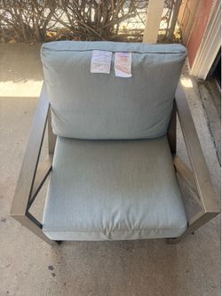 Outdoor Sunbrella aluminum chair with green cushions