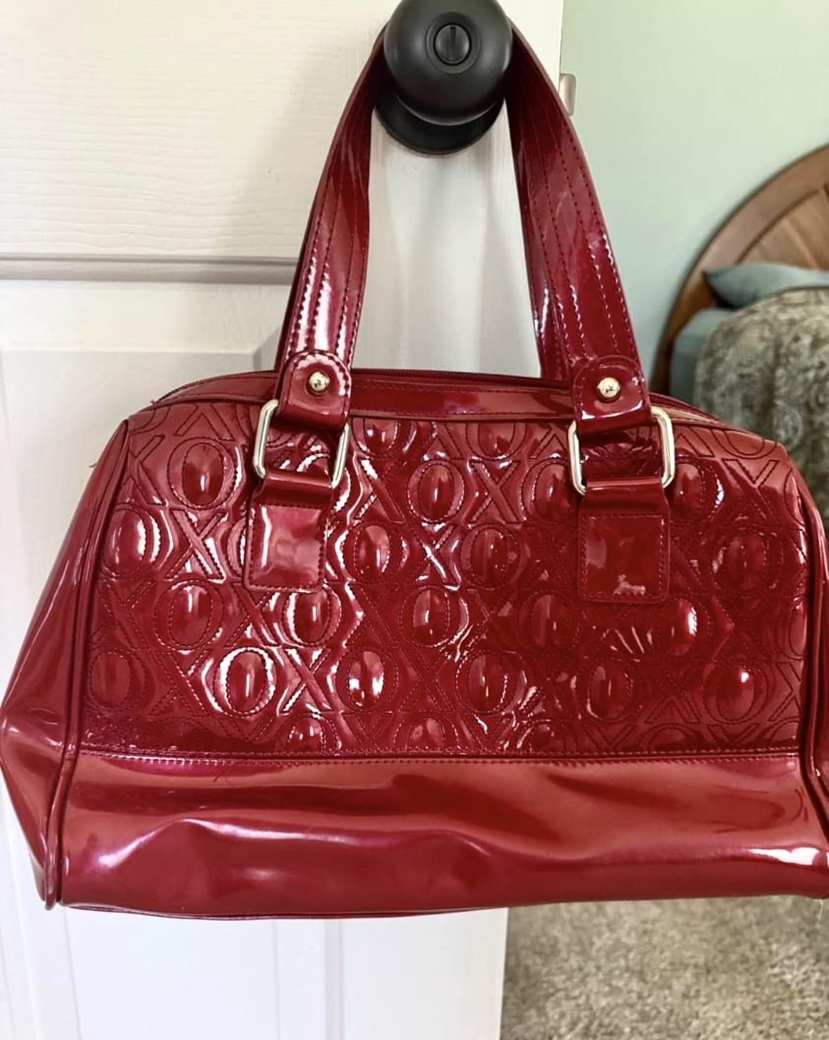 Used XOXO brand glossy patent leather handbag. Burgundy w/ 2 handles