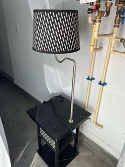 Wooden side table with satin finish lamp shade (has built in usb port and charger)  Located in Hayward  Fully functional   Measures 56” high  Table is