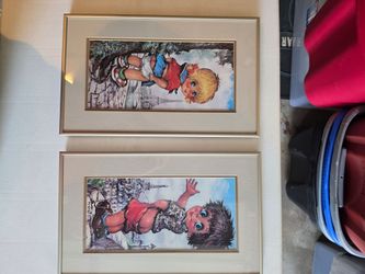 This pair of vintage framed prints features "Big Eye" children in Paris by artist Michel Thomas, commonly known as "Poulbots" art