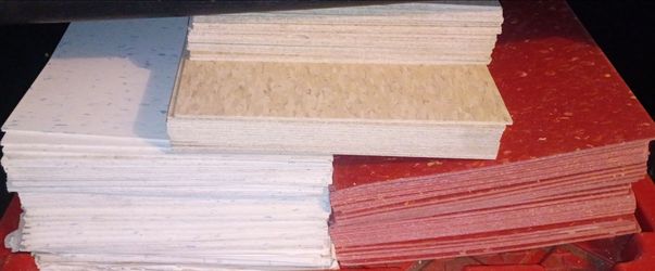 3 different colored stacks of flooring tiles