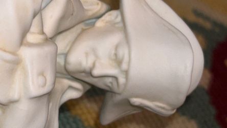 vintage white porcelain figurine depicting Napoleon Bonaparte standing next to a horse with a wounded soldier on the ground, likely produced by the Ge