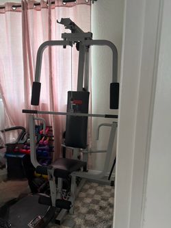 Weider 8920 Home Gym with 4 10lbs weights and 4 20lbs weights.