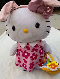Large Hello Kitty plush wearing pink floral dress with flower basket.
