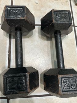 (2) used 25 lb dumbbells