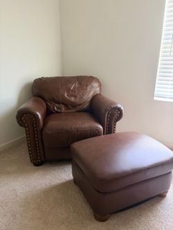 Brown leather armchair with matching ottoman