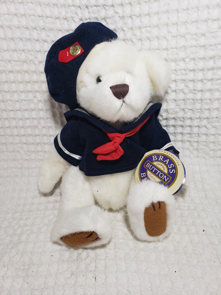Brass Button bear plush . Measures 10" . Good condition and smoke free home. 