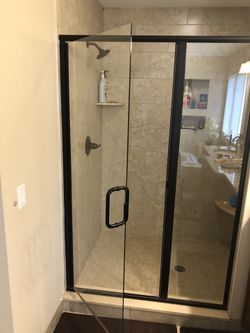 Semi frameless oil rubbed bronze shower door 46.5” wide which includes shower door and side panel assembly
