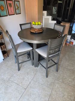 Bar Height dining room table 4 chairs.  2 years old
