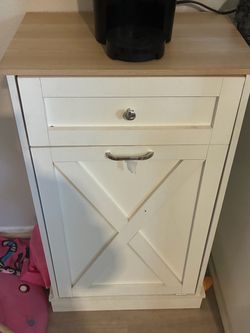 Tilt out trash cabinet