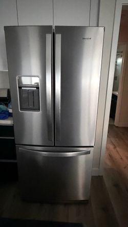 Barely used whirpool refrigerator with French doors and water and ice maker