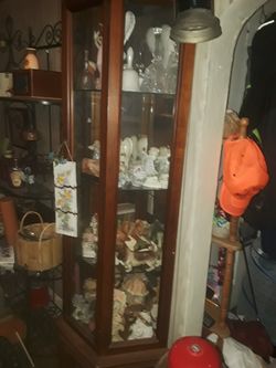 Nice. Lighted curio Cabinet measurements are 71 in tall 20 in wide has a door at the bottom for storage