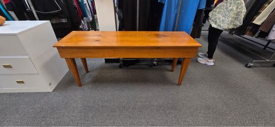 wooden/farm bench with a rectangular plank top and four tapered legs