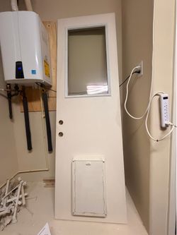 Pre-owned Doggy Door With Glass Side  Door  30x95 , one side white, another side-brick color , pick by 89131 zip, by Floyd’s Lamb park