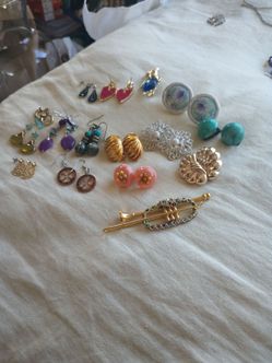 13 pair of vintage earrings clip-on backs some are regular hooks one owl pin and one Christmas ornament all for $100 each one is worth 20 to $30 the v