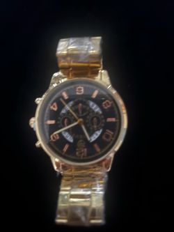 New gold Stainless Steel watch with a black dial. This timepiece has a link bracelet band and a round case. The dial features rose gold-colored hour m
