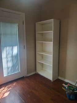 Tall white bookcase with 4 shelves