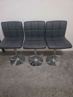 Gray with silver base swivel adjustable bar stools.