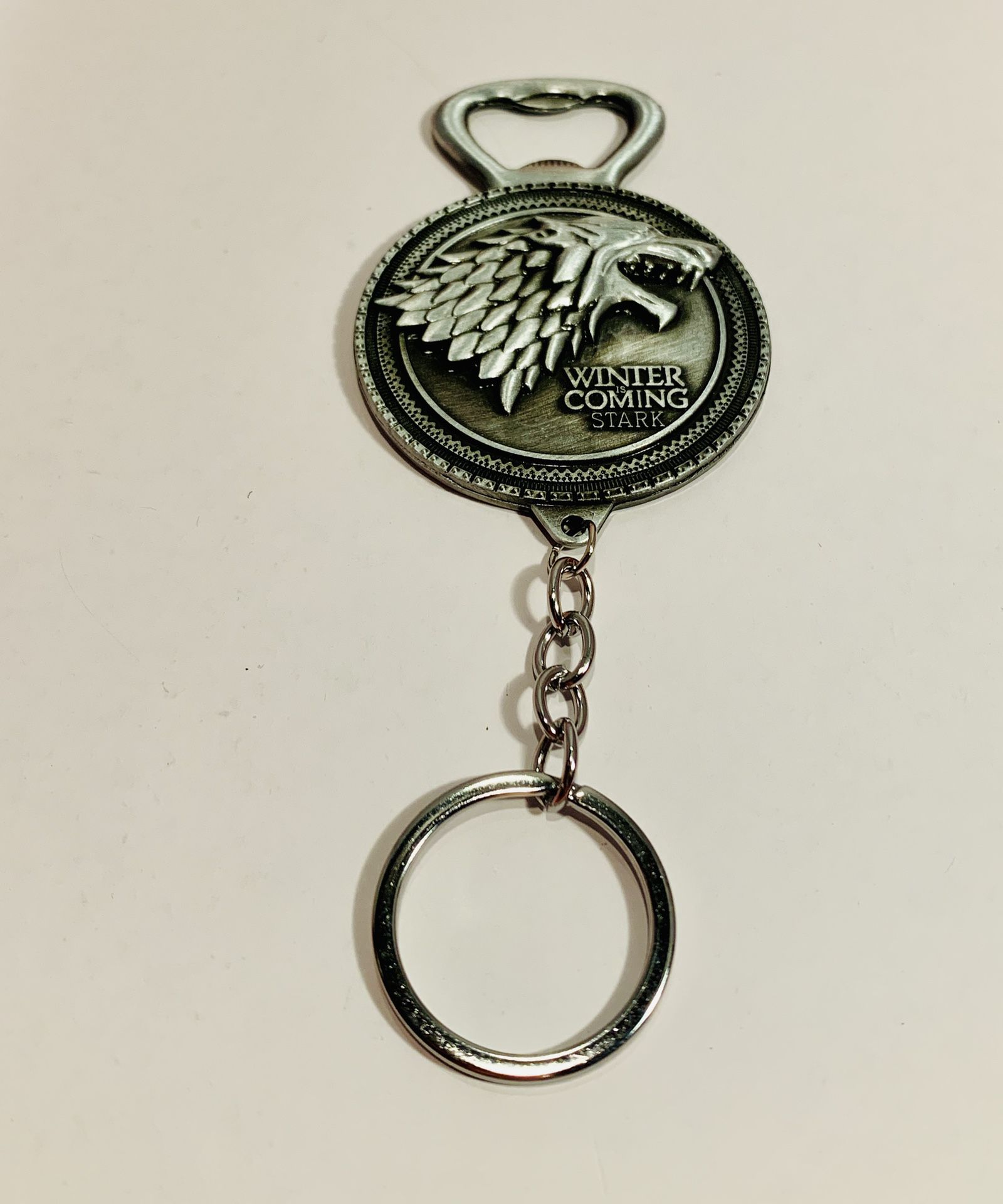 Game of Thrones-Inspired House Stark Keychain/Bottle Opener - Silver Color.   Measures 5.5” long   Smoke free house