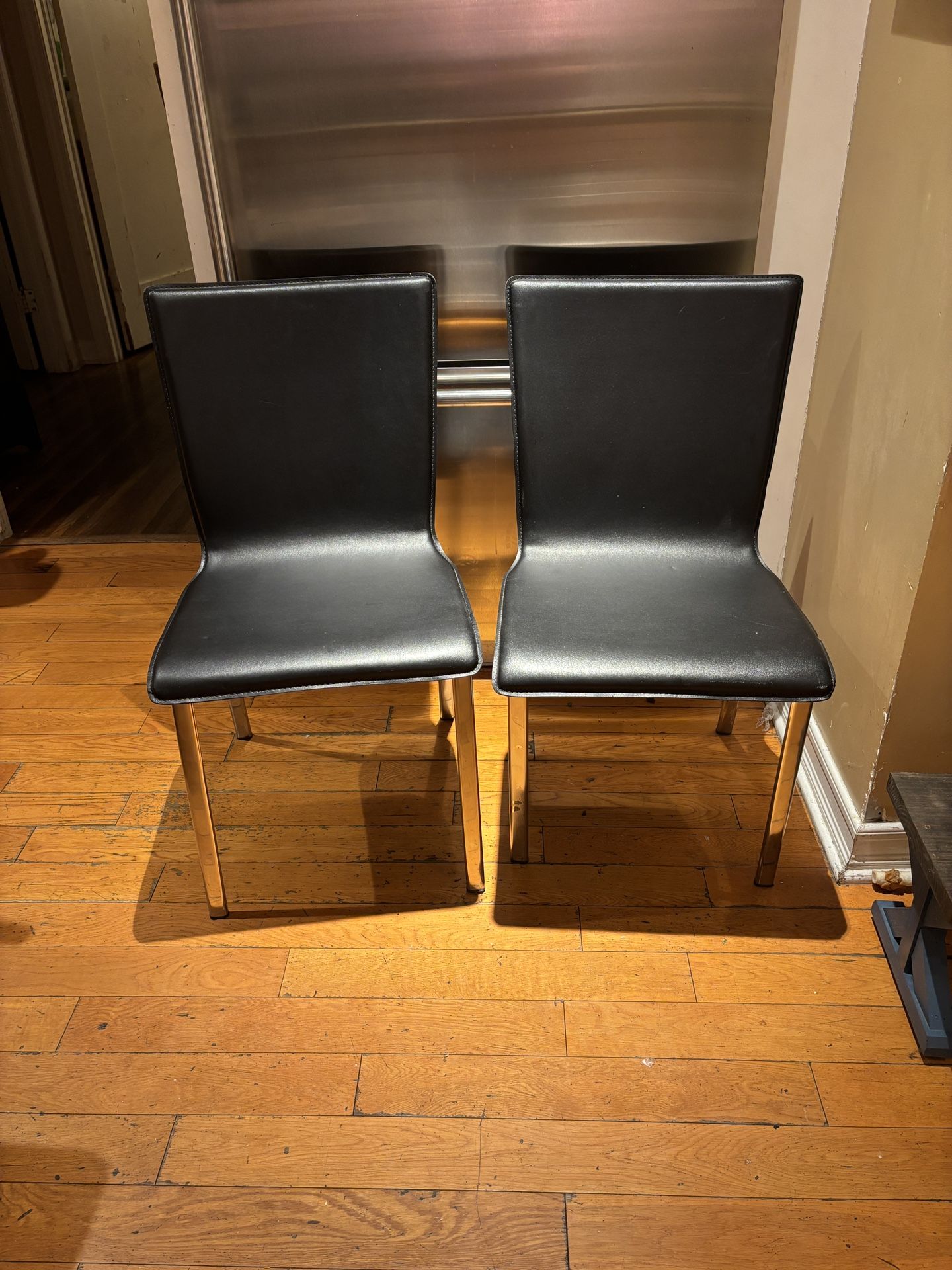 Black Leather Dining Chairs With Nickel Plated Legs CB2 - Set of 2