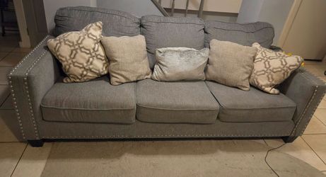 Gray couch with pillows