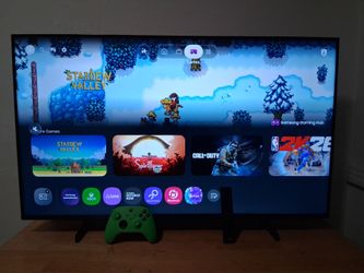Samsung 43 inch QLED 4k UHD Smart TV with lime green Xbox controller