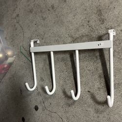 white metal over-the-door or under-shelf hanging rack with four hooks