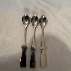 12 silver spoons with hearts on the handle.