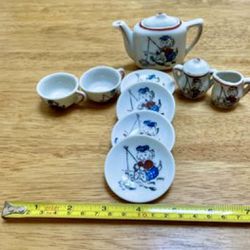 11 piece vintage/1940s porcelain collectible tea pot, tea cups, sugar and creamer, and for dishes.