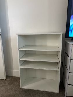 White adjustable shelving unit/book case