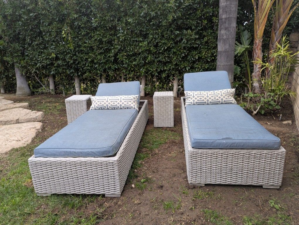 Two Outdoor Lounge Chairs And Side Tables