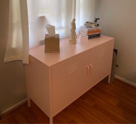 Pink industrial metal cabinet with locker-style vented doors