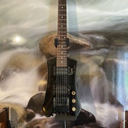 Cort Electric Guitar Cort Steinberger licensed headless electric guitar black. In great playing condition. Brand gold tuning knobs. It’s been amp test