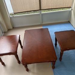 A wooden three-piece end table set