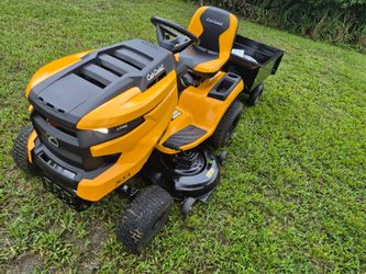 23hp Cub Cadet XT1 Riding Mower 46"cut. With pull behind dump trailer low hrs