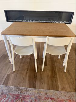 IKEA table with 3 white chairs and 1 bench