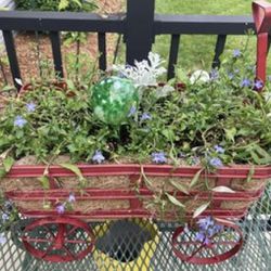 Red Metal Cart Planter. Wheels Turn. Handle Moves.