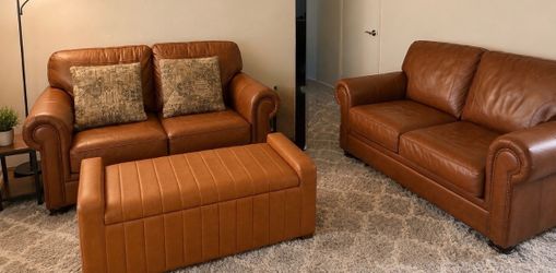 Two brown leather couches