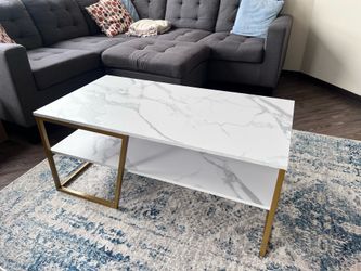 Modern coffee table with white marble-look top and gold metal frame in excellent condition $65