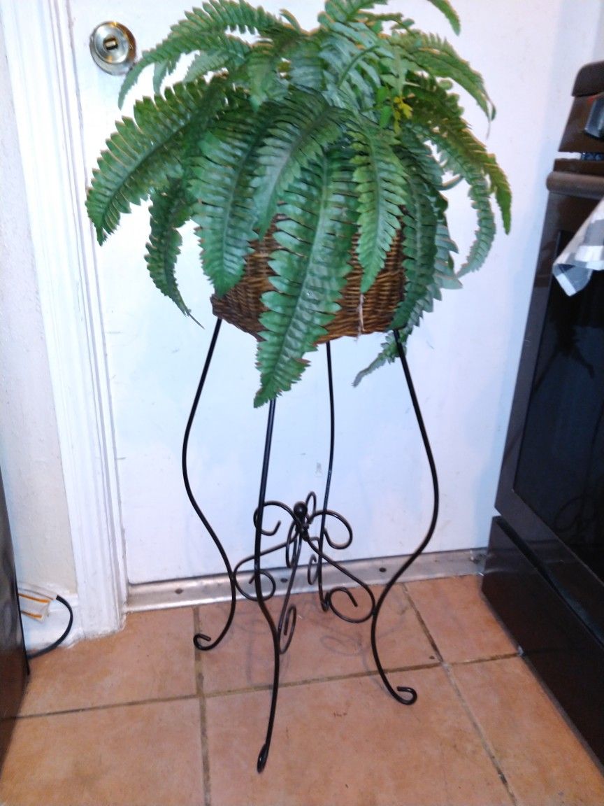 Fake plant in basket on metal stand $15 40 inches tall x 16 round