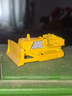 vintage yellow Matchbox No. 64 Caterpillar D9 Bulldozer die-cast toy car from 1979 (Lesney)